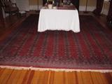 A Persian Bokhara carpet 10'1" X 13'11".  Some moth damage at one edge.