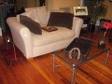 Comfy love seat sofa with pillows.  Wrought iron and glass table.