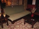 An upholstered futon sofa bed with a pair of side tables and coffee table from Thailand