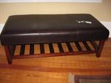 Leather covered bench with shelf below