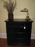 Black painted chest, decorative arrangement and lamp