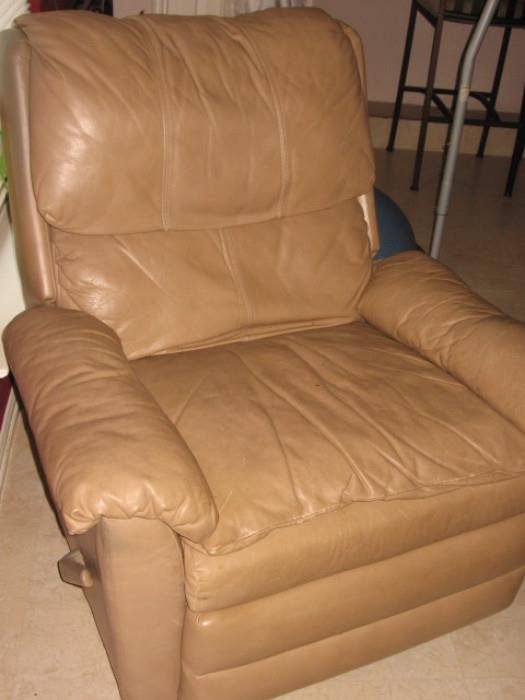 One of two twin tan leather rocker recliners