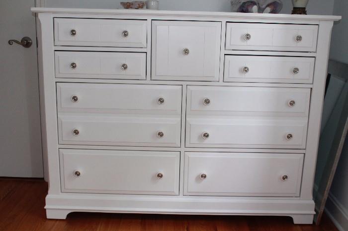 White double dresser with matching triple dresser, chest, platform bed, and two bedside tables