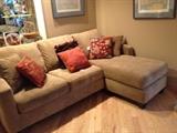 Small Sectional in beige with colorful pillows