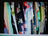 A view of some of the vintage ladies clothing to be sold, a nice display of fine garments, purses and more.