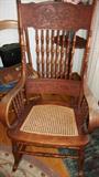 dragon carved pressed back chair with spindles andc woven seat