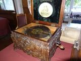 Highly carved Symphonion music box, open. Includes six discs.