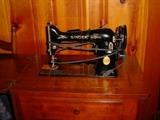 antique Singer sewing machine in vintage cabinet