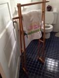 A towel rack PERPOSED PAIR OF CRUTCHES. 