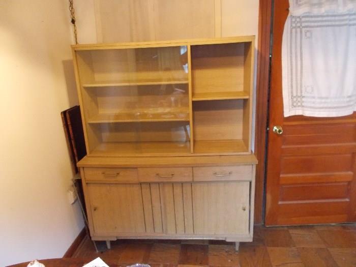 Mid Century Modern Hutch/China Cabinet - 2 pieces - top piece has 2 sliding glass doors - 3 shelves on left side - 2 shelves on right side  -  bottom pieces has 2 drawers and 2 sliding doors - 48" wide & 63" tall...