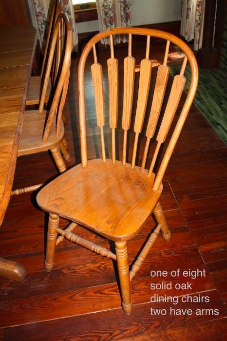 solid oak chair. one of eight. two chairs have arms