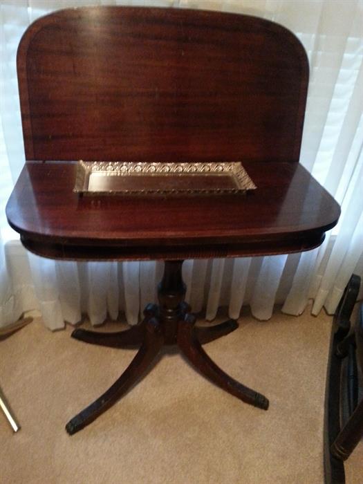 Gorgeous antique mahogany table with folding top and claw feet