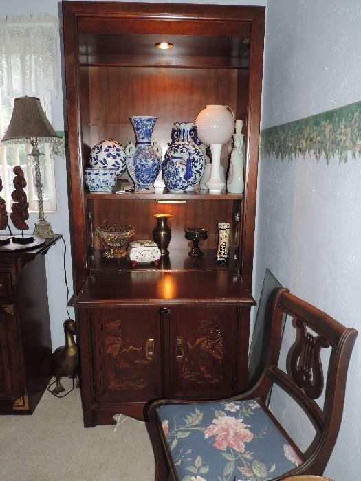 Elegant Cabinet with Light and Decor, Harp Back Chair in Front