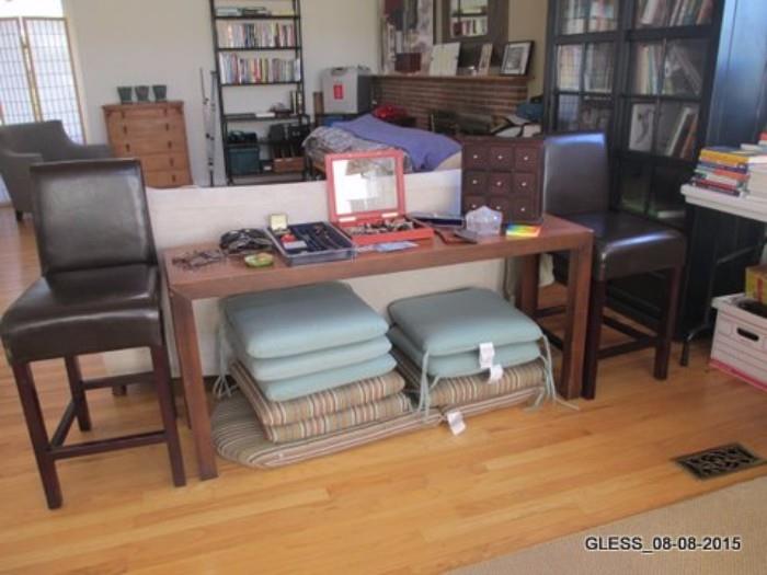 Leather Bar Stools, Sofa Table, Cushions for Teak Furniture. (Black Bookcase in background is Not For Sale)