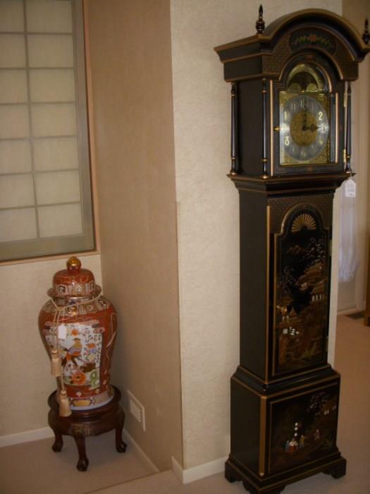 Sligh tall case (Grandfather) clock with Chinoiserie decoration.  On the landing is a temple jar on stand. Note: the clock does not run.