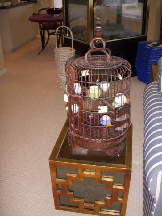 Oriental bird cage (purchased at Gump's in San Francisco) on a mirrored side cube-shape table