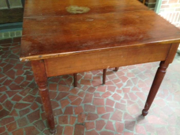 Square cherry table--perfect for games or dining.  One marred place on top likely easily repaired. 