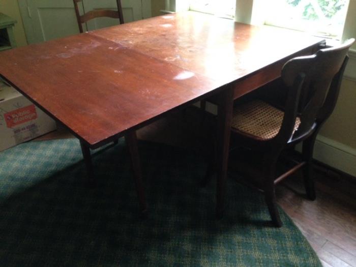 Table with 2 drop leaves (one leaf raised in this picture); needs serious cleaning, maybe even refinishing, but price reflects that.  Once re-done will be a treasure to keep or resell at high dollar level. 