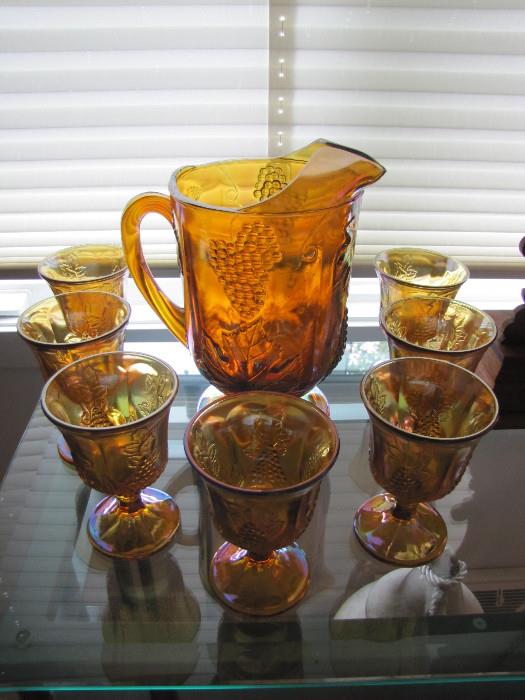 Matching carnival glass pitcher and goblets