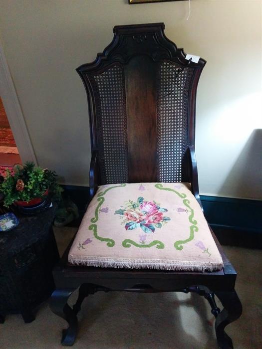 A large and imposing chair of mahogany in the Queen Anne style, with caning.  Probably Dutch.