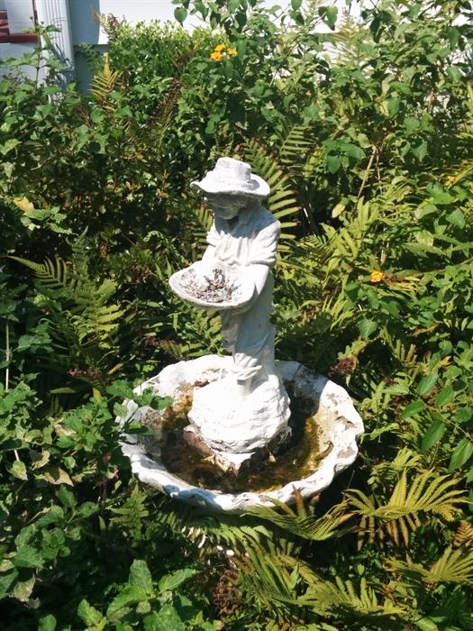 Tiered fountain in garden.