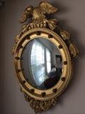 Early American convex gilded mirror.