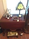 Mahogany rolling cart with glass shelf, Miller Arts and Crafts slag glass lamp antique foot stool, pewter teapot and stand with creamer and sugar on Kirk Stieff tray