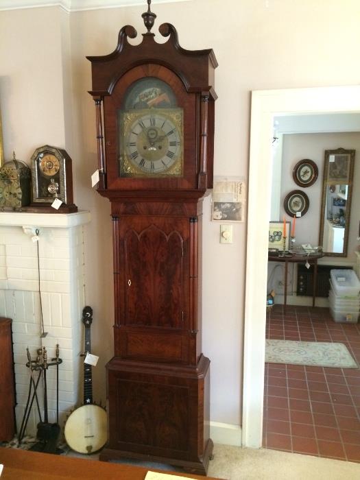 R to L : Long case, moon phase clock of English origin in antique black walnut case, turn of the century banjo, fireplace tools