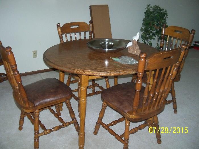 table with six chairs and 2 leaves