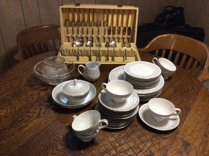 Vintage china, flatware, round wood dining table and chairs