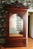 20 - Rosewood rococo 1 door wardrobe, has laminated crest, mirrored door and fitted interior, 8 ft. 9 in. T, 56 in. W, 26 in. D., ca. 1850.
