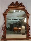 26 - Walnut Renaissance over the mantle mirror with carved cupids in crown, attar. to Herter Brothers, ca. 1875, 7 ft. 7 in. T, 61 in. W.
