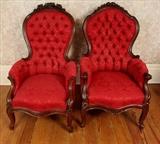 33 - Matched pair walnut armed parlor chairs with burgundy upholstery and roses carved in crown, ca. 1870, 45 in. T, 25.5 in. W, 21 in. D.
