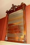 73 - Mahogany over the mantle mirror with carved heads on crown.
