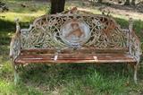 123 - Large heavy matched pair of solid cast iron garden benches with crest of lady and bird, matches # 121, 41 in. T, 72 in. W, 15 in. D.
