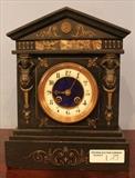 183 - Black state clock with different colors of inlay marble and applied designs, ca. 1870, 12 in. T, 9 in. W, 6 in. D.

