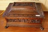 202 - Carved walnut tabletop wood display case with lid, very detailed, raised carving and hairy paw feet, 18 in. T, 28 in. W, 19in. D.
