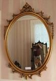 303 - Oval gilt wall mirror with pierced frame, 38 x 27.
