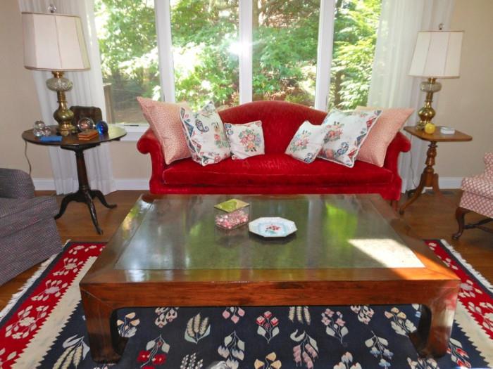 Red velvet sofa and coffee table