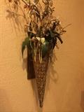 One of two cone-shaped wall decor arrangements