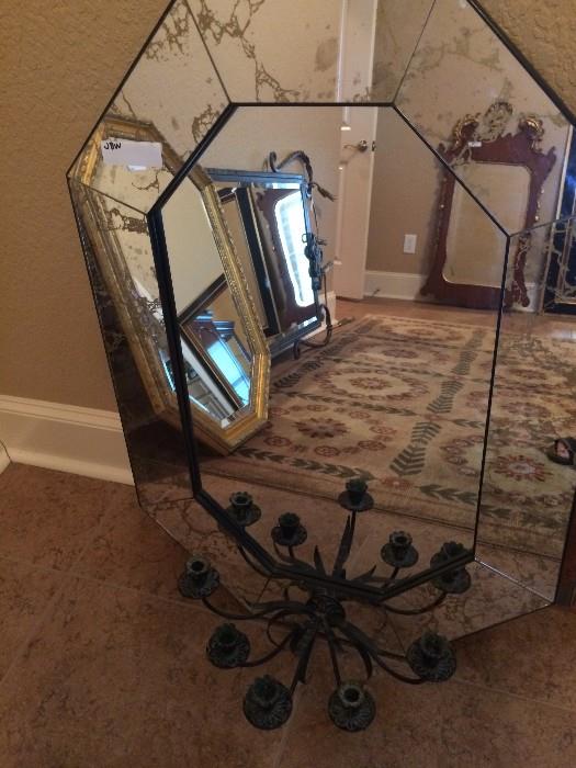 This mirror has attached candelabra in the lower front.