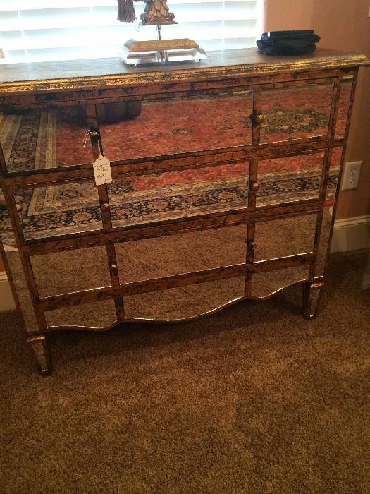 3 drawer mirrored chest (rug is reflecting in the chest)