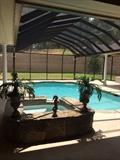 The screened-in pool area is a special feature of this lovely home.