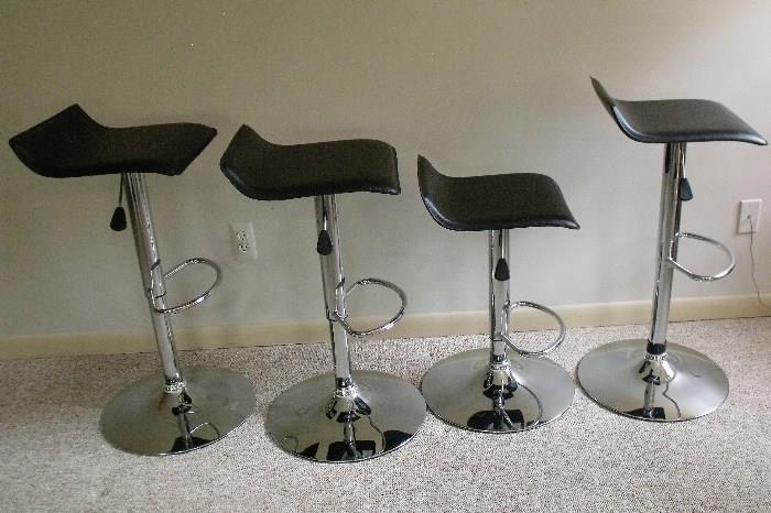 4 bar stools. Chrome with black leather seats. All chairs have adjustable height.