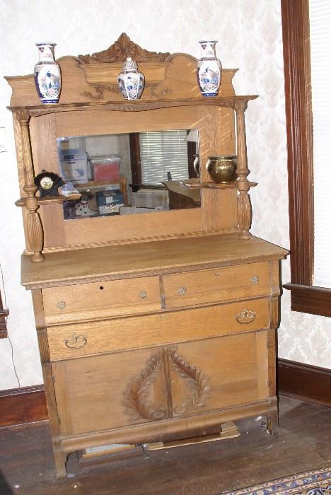Oak carved buffet with high mirrored pedestal back.45x 23x78  $750.00