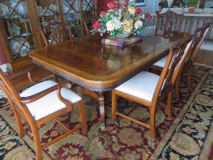 OXFORD CLASSIC BANDED FLAME MAHOGANY DINING TABLE PERIOD STYLE W/ BRASS TIP CLAW FEET & ASTON COURT CHAIRS
86" X 52" W THREE 23" LEAVES AND PADS
HENREDON
