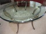 ROUND GLASS TOP COFFEE TABLE
METAL BASE WITH LOWER MEDALLION ACCENT
