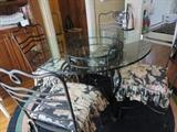 GLASS TOP WROUGHT IRON KITCHEN TABLE AND CHAIRS WITH CUSTON CUSHIONS

