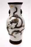 Lot 143: Chinese Qing Dynasty crackleware vase having applied fighting
dragons on the front and a crane on the reverse with double
zoomorphic handles, incised upper and lower borders, measuring
17.75" tall, partially visible hallmark is covered in an attempt to 
repair an old drilling for lamp conversion, c.mid 1800's
est. $400.00-$600.00