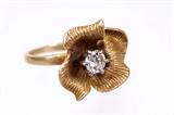 Lot 95: 14K diamond flower ring set with a round brilliant cut
diamond approx. 0.50 carats, VS1 clarity, G-H colour weighing
5.4 grams, retail replacement value $1,950.00 est. $450.00-$650.00